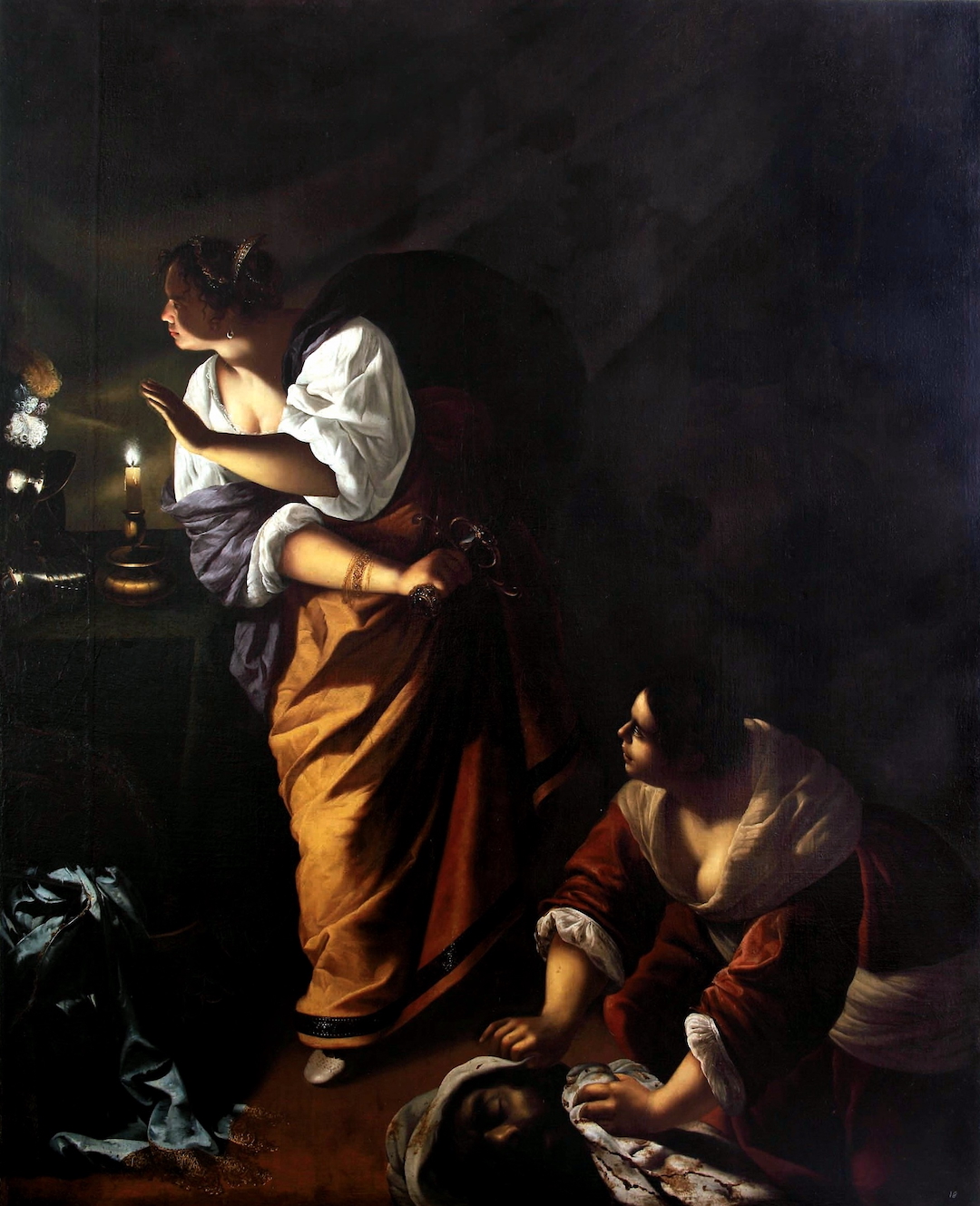 Judith und ihre Magd Abra im Kerzenlicht, die den abgeschlagenen Kopf des Holofernes verbergen.
